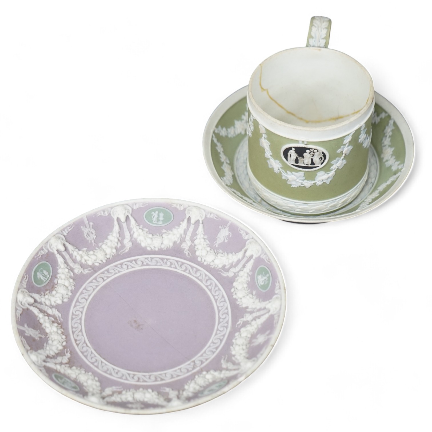 A Wedgwood three colour, green ground jasper cup and saucer and a single lilac ground saucer, early 19th century, 13.5cm. Condition - poor